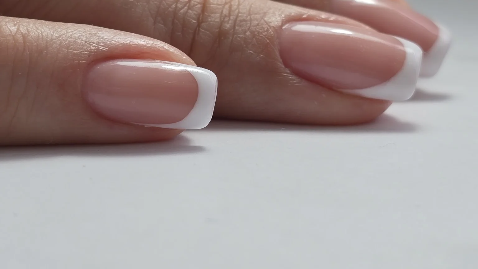 A clean French manicure, close up